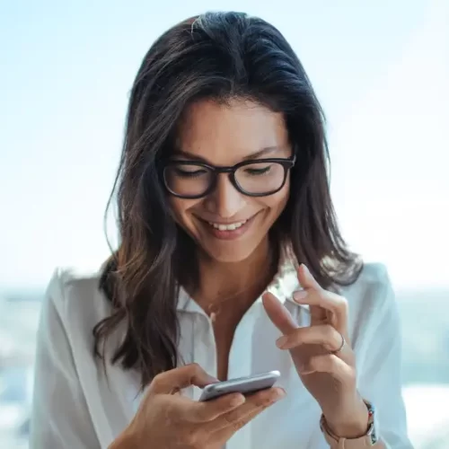 happy woman looking at mobile phone